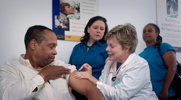 Nurse giving a man a vaccination - photo courtesy of Centres for Disease Control and Prevention (CDC) - via Unsplash